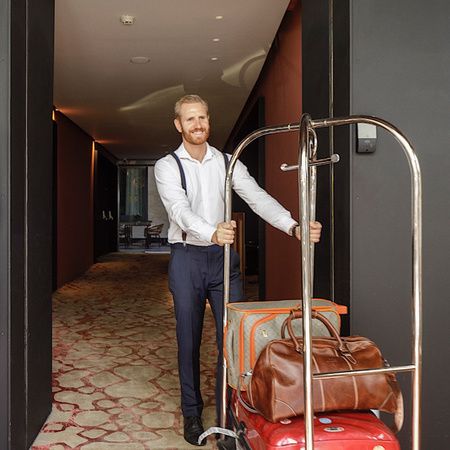 Staff with luggage at the EME Catedral Mercer Hotel